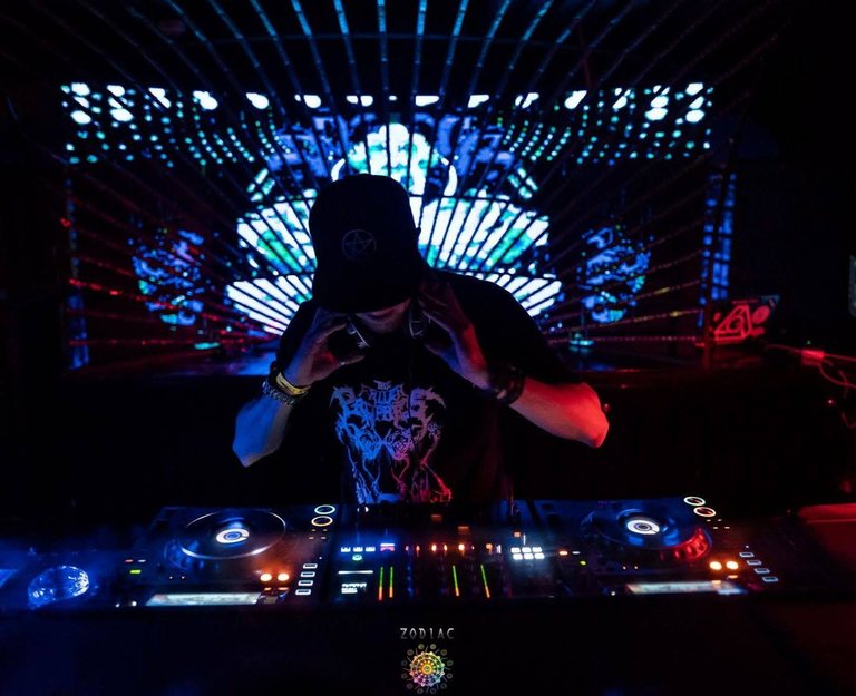 DJ Archive at the decks under dark stage lighting