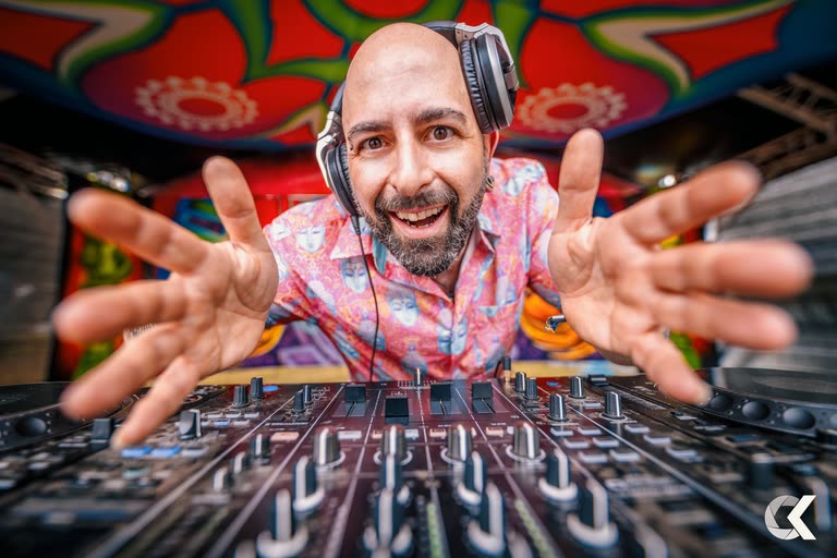 Champa reaching toward the crowd from behind the mixer